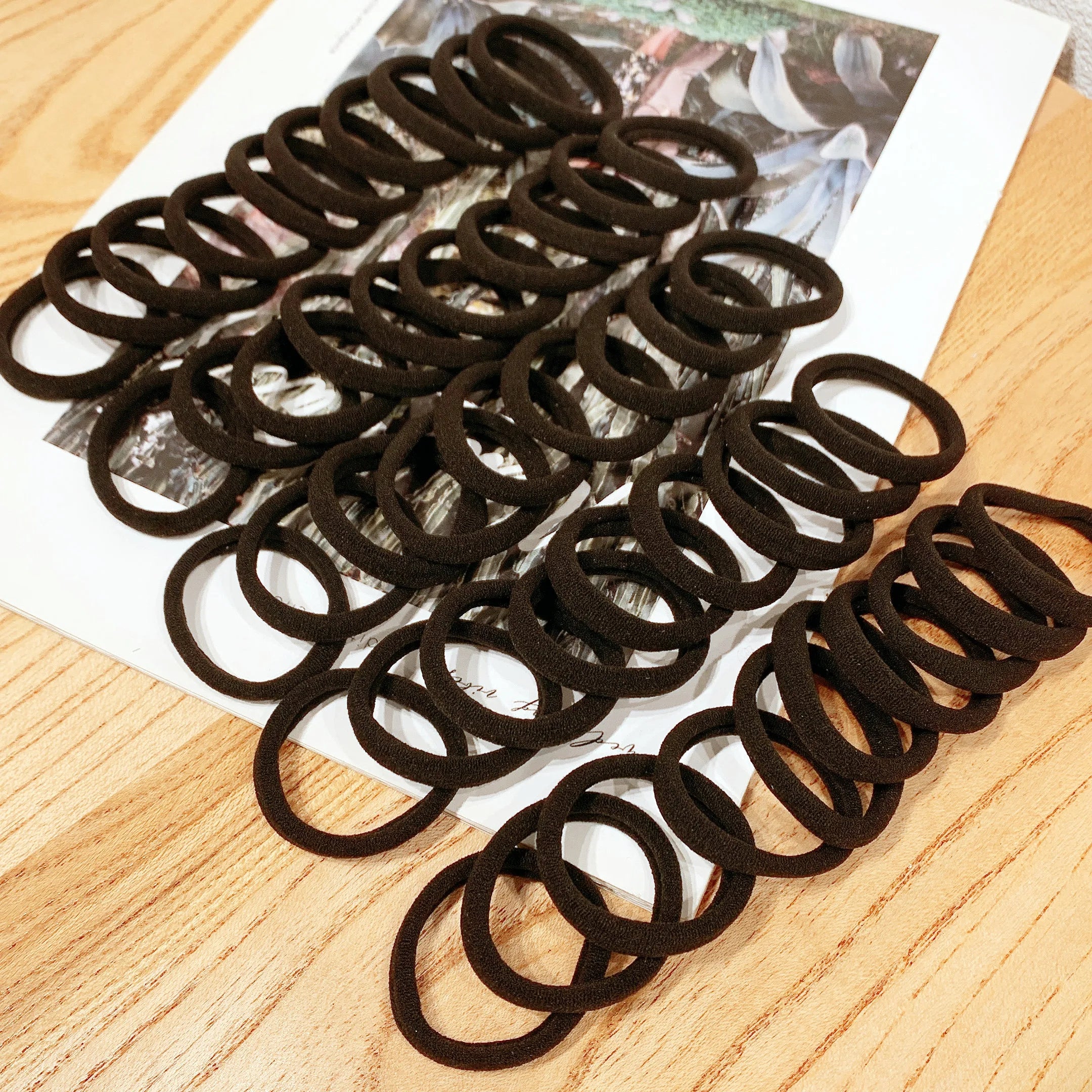 50/100 pcs Elastic Hair Bands – Strong & No-Damage Hair Ties (Black)